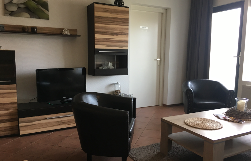 Foto Wohnzimmer Beach Appartement 4 mit Sofa, Couchtisch und Sesseln